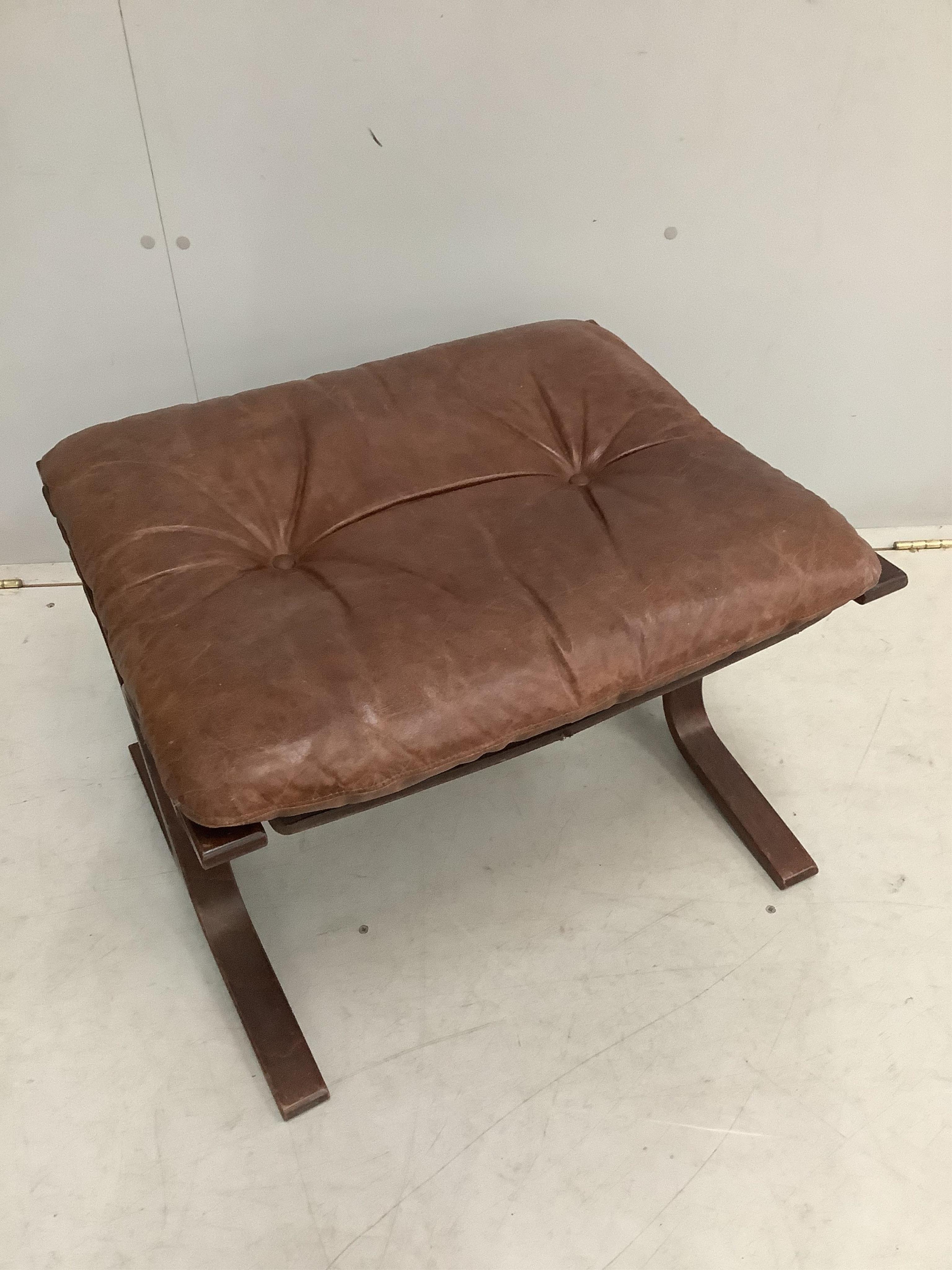 An Ingmar Relling leather chair, width 62cm, depth 66cm, height 98cm and footstool, Siesta